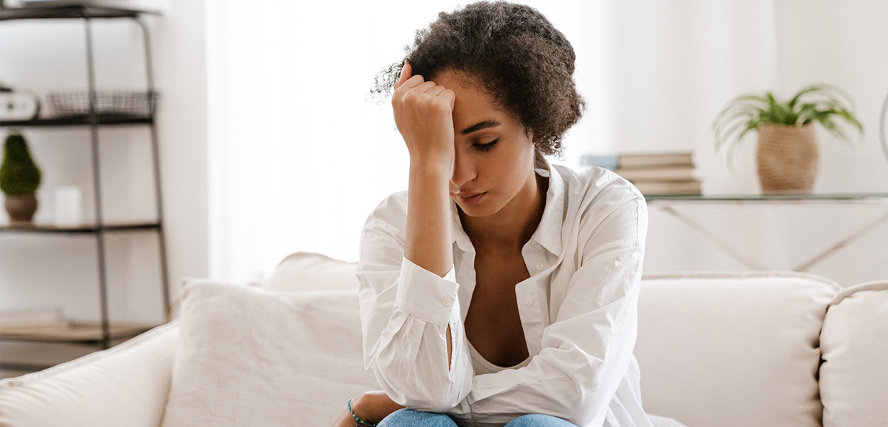 Person looking distressed and overwhelmed alone