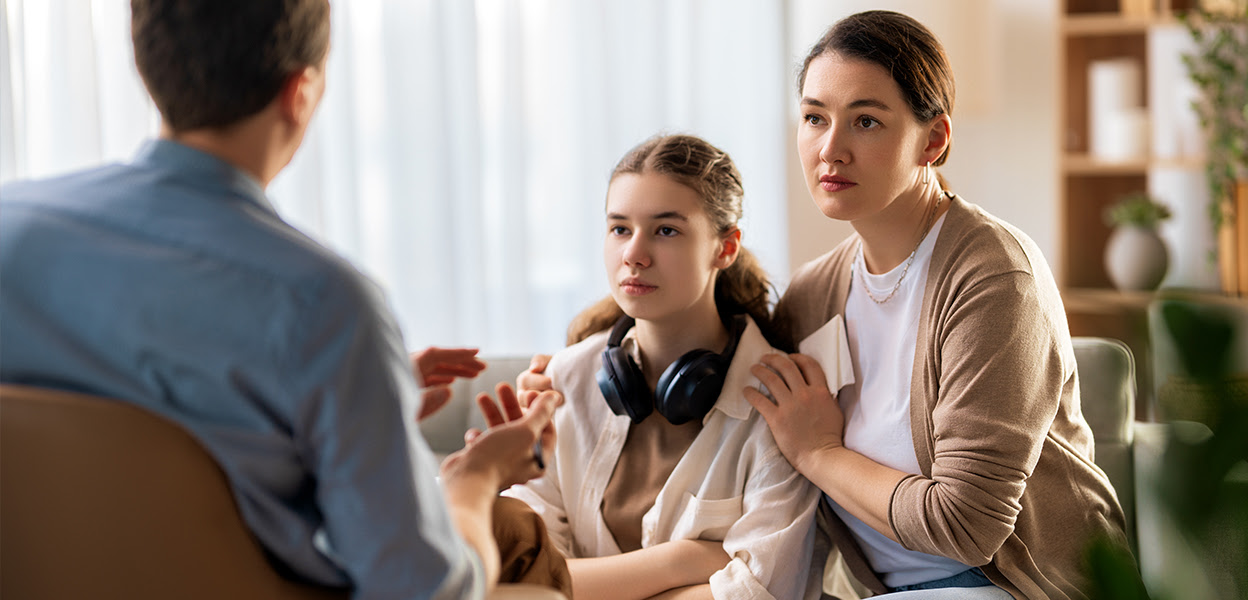 Frustrated teenager refusing to talk to therapist